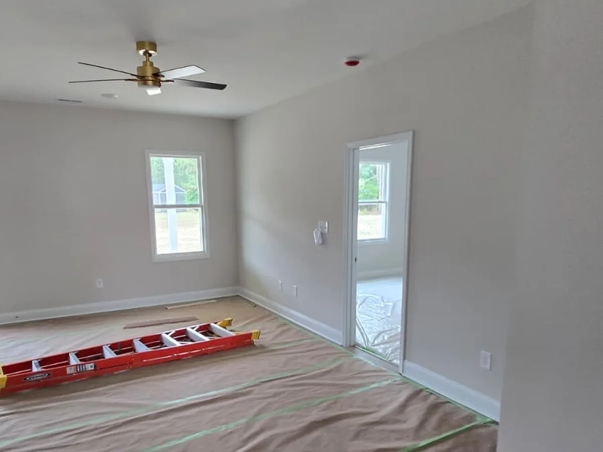 Painted living room with two windows and white trim